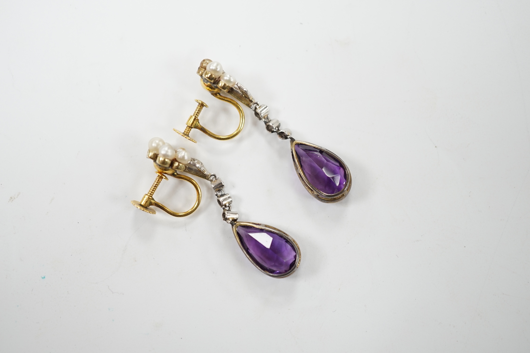 A pair of early to mid 20th century 9ct, amethyst, diamond and seed pearl set drop ear clips, 34mm, gross weight 4.7 grams. Fair to poor condition.